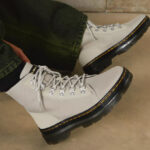 A Person Wearing Dr Martens Combs Womens Poly Casual Boots in Stone Color