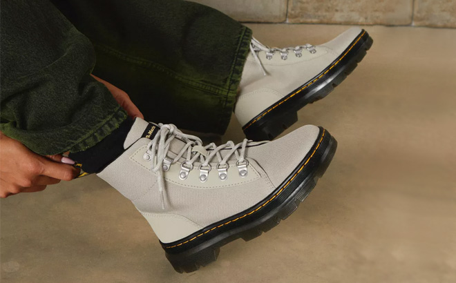 A Person Wearing Dr Martens Combs Womens Poly Casual Boots in Stone Color