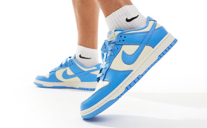 A Person Wearing Nike Dunk Low Retro Shoes in White Carolina Color