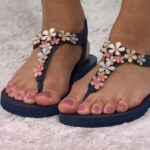 A Person Wearing the Skechers Meditation Embellished Thong Sandals