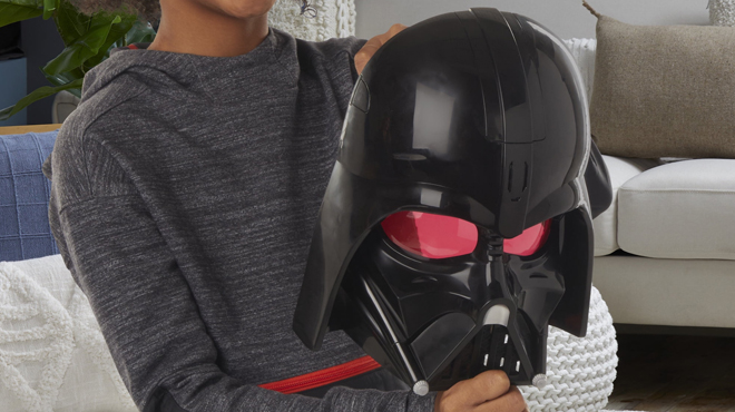 A Person holding a Star Wars Darth Vader Electronic Mask