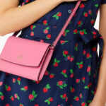 A Person wearing a Kate Spade Perry Leather Crossbody Bag