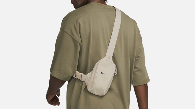 A Person wearing a Nike Sportswear Essentials Crossbody Bag