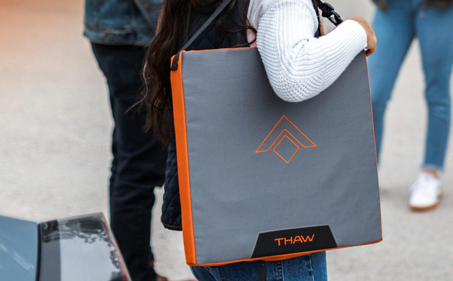 A Woman Carrying on the Thaw Rechargeable Heated Seat Pad