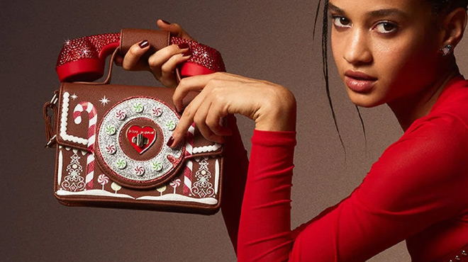 A Woman Holding Betsey Johnson Kitsch Gingerbread Phone Bag