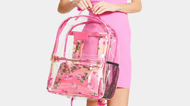 A Woman Holding Betsey Johnson Large Floral Print Clear Backpack