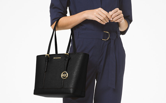 A Woman Holding Michael Kors Jet Set Travel Small Saffiano Leather Top Zip Tote Bag