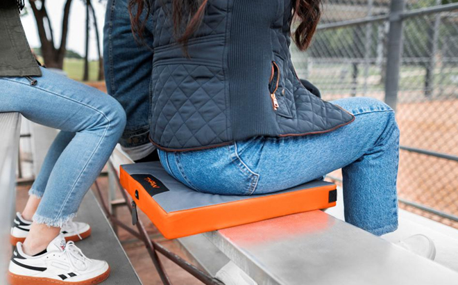 A Woman Sitting on the Thaw Rechargeable Heated Seat Pad