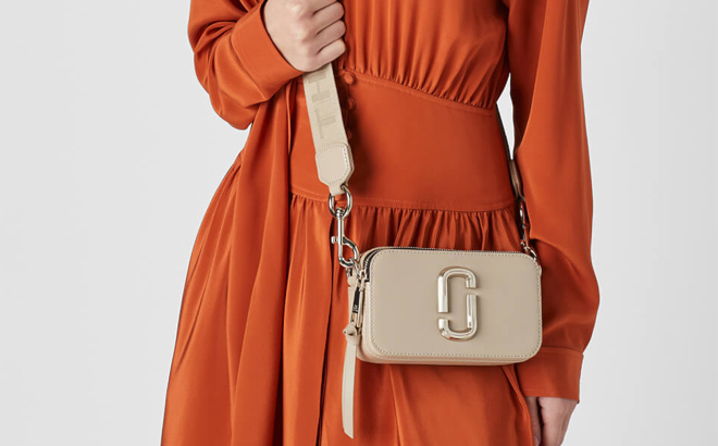 A Woman Wearing Marc Jacobs The Snapshot DTM Bag in Khaki