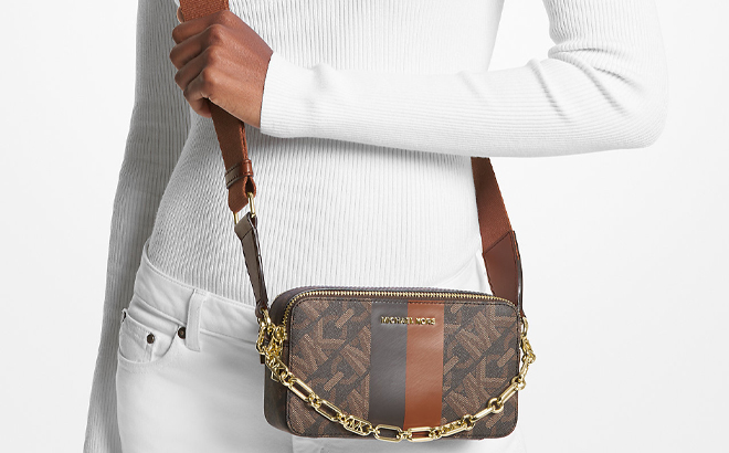 A Woman Wearing Michael Kors Jet Set Small Empire Signature Logo Stripe Double Zip Camera Bag