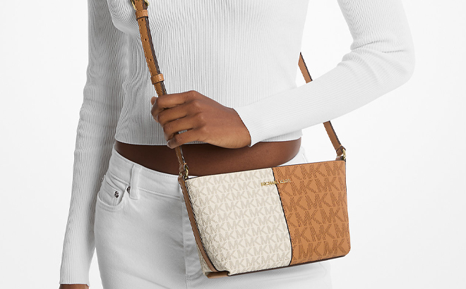 A Woman Wearing Michael Kors Jet Set Small Two Tone Logo Crossbody Bag