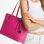 A Woman Wearing Michael Kors Jet Set Travel Small Saffiano Leather Top Zip Tote Bag