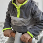 A chid wearing a Oshkosh Toddler Microfleece Pullover