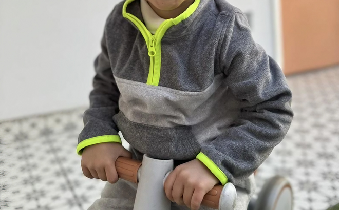 A chid wearing a Oshkosh Toddler Microfleece Pullover