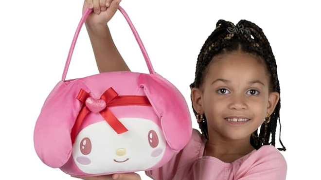 A girl holding a Hello Kitty My Melody Valentine 12 inch Plush Pail