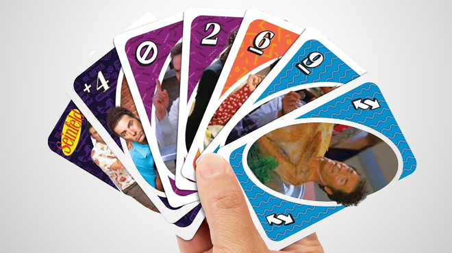 A hand holding a Mattel UNO Seinfeld Edition Card Game Card