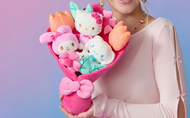 A lady holding Hello Kitty 12 inch Plush Valentines Bouquet