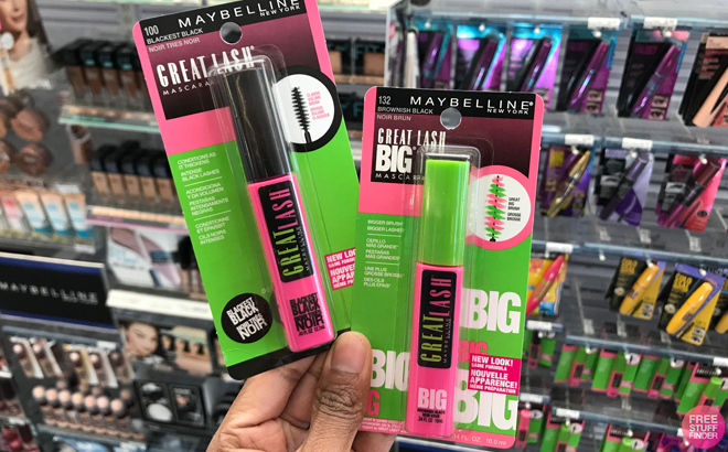 A person holding two Maybelline