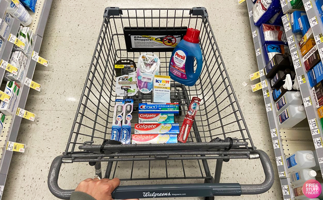 A person pushing a shopping cart at Walgreens filled with Personal Care items