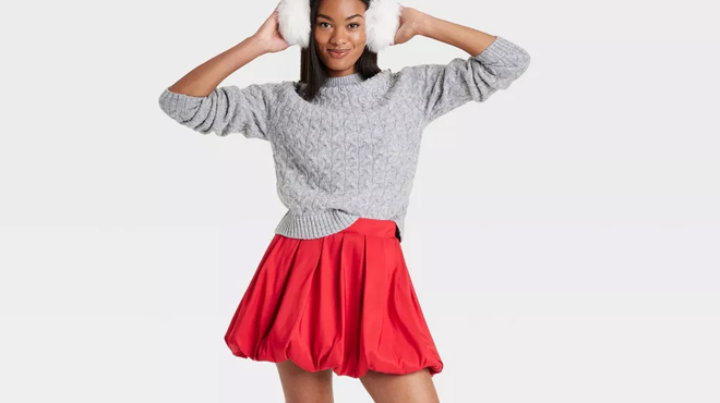 A person wearing a A New Day Womens Cable Crewneck Pullover and A New Day Womens Bubble Hem Mini Skirt