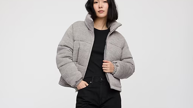 A person wearing a GAP Factory Relaxed Short Puffer Jacket