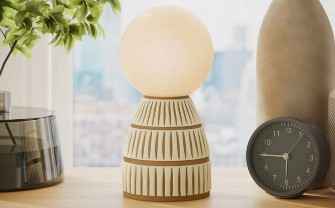 Beautiful by Drew Barrymore Ceramic Brown Ribbed Frosted Globe Table Lamp on the Table