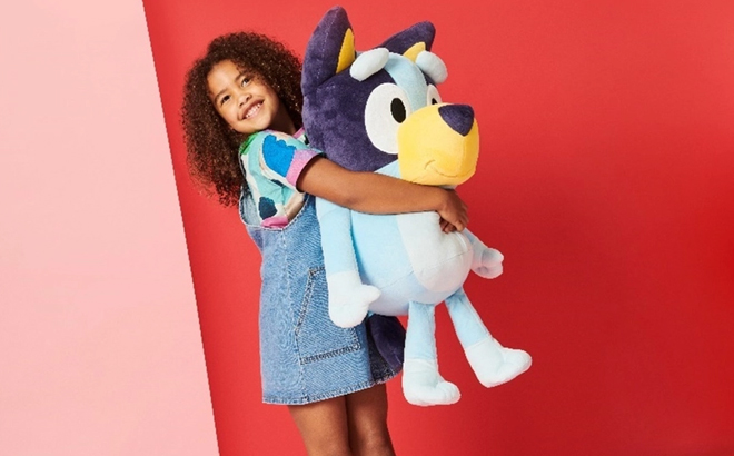 Girl Holding a Large Bluey Toy