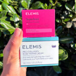 Hand holding Elemis Pro Collagen and Superfood Creams