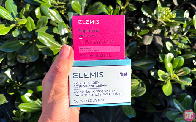 Hand holding Elemis Pro Collagen and Superfood Creams