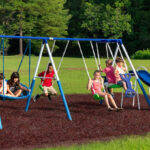 Kids playing on XDP Recreation Playground Swing Set