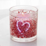 Room Essentials Sugared Watermelon Light Up Gel Candle on a Table