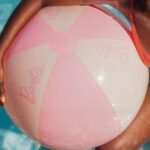 a Person Holding Funboy Barbie Giant Beach Ball in a Pool