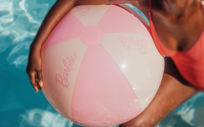 a Person Holding Funboy Barbie Giant Beach Ball in a Pool