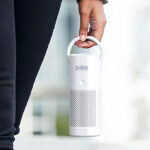 A Woman Holding Pure Enrichment Pure Zone Mini Portable HEPA Air Purifier