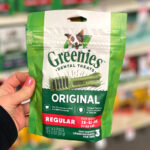 A Woman Holding a Bag of Greenies Dog Dental Treats