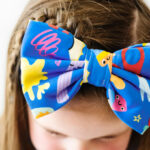 A Girl Wearing Make and Create Luxe Bow Headband