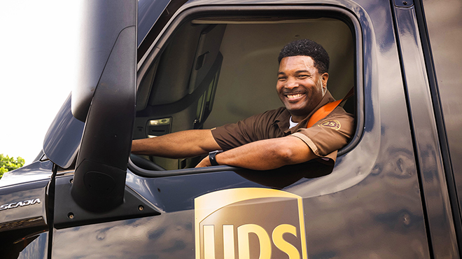 A Smiling UPS Driver in a UPS Van