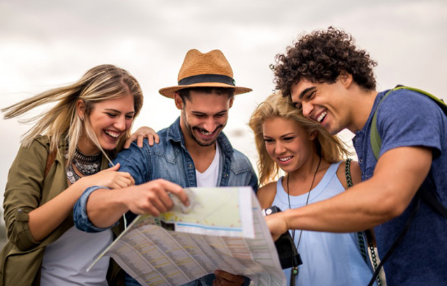 College Students Looking at the Map and Smiling