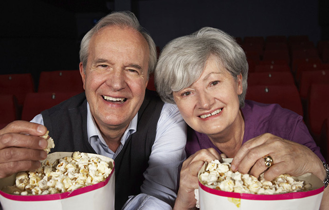 Senior Couple at Cinema Eating Popcorn