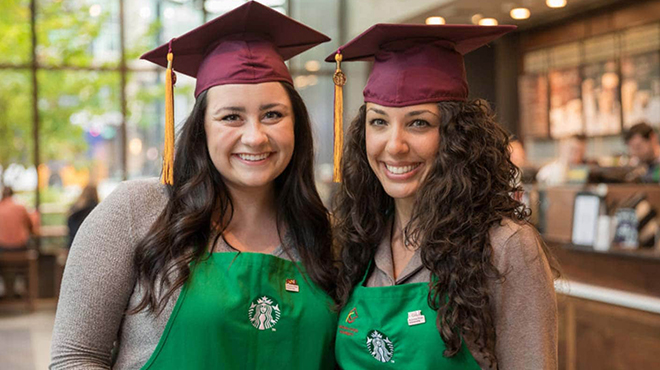 Two Starbucks Employees with Graduation Caps