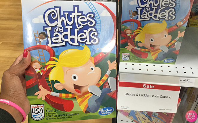 A Hand Holding Chutes and Ladders Board Game