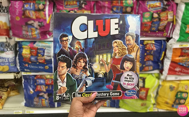 A Hand Holding Clue Board Game