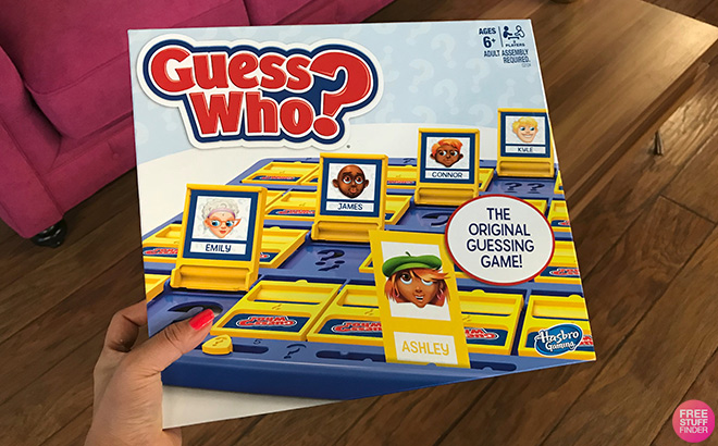 A Hand Holding Guess Who Board Game