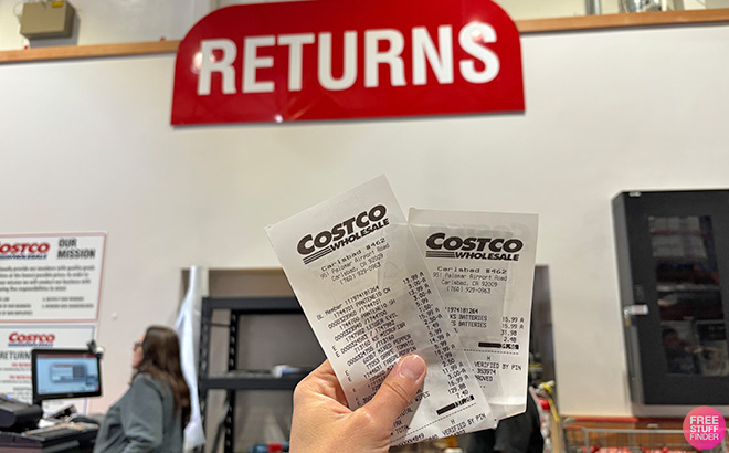 A Hand Holding Receipts at Costco Returns