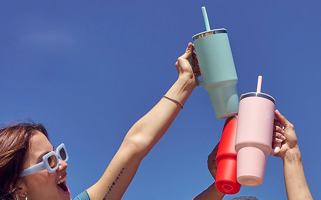 People Holding Hydroflask Tumblers in the Air