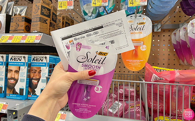 A Hand Holding a Coupon and Bic Soleil Razor Pack at Walmart