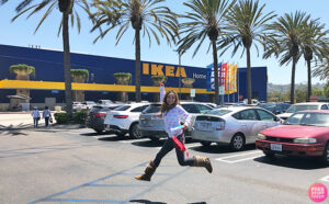 A Woman Jumping in Front of Ikea